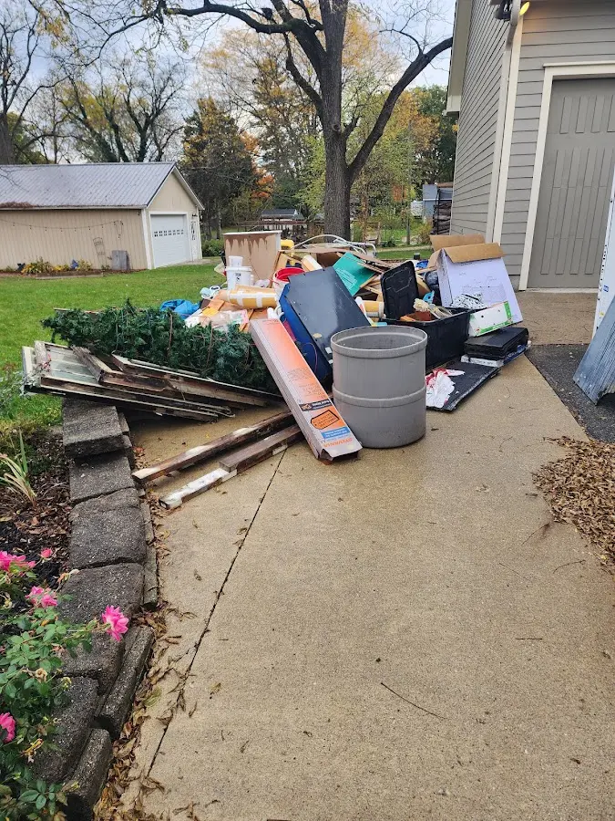Dumpster being loaded with debris for Estate Cleanout Dumpster Rental in New Whiteland
